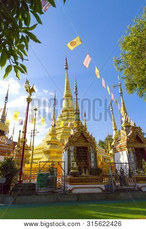 Architecture Gold  Idyllic With Sunshine And Blue Sky At Wat Phra Bat Ban Tak, Tak Province, Of Thai