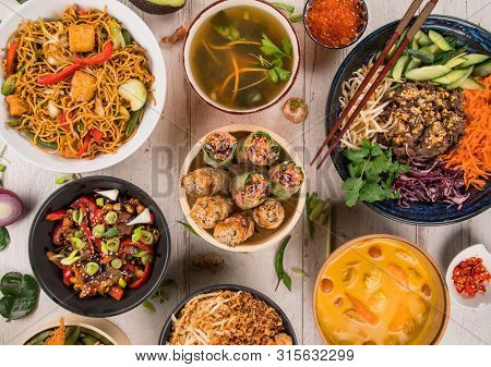 Asian food background with various ingredients on rustic wooden background , top view. Vietnam or Thai cuisine.