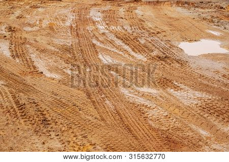 Dirt Road, Urban Non Asphalt Traffic Way With Tire Tracks Of Many Type Of Vehicles.