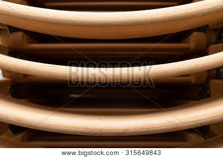A Closeup Of Folded Light Colour Wooden Folding Chairs