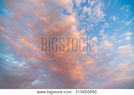 Fantastic Sunset Sky In Colors From Purple To Orange. Sky Background From Dramatic Clouds . Panorama