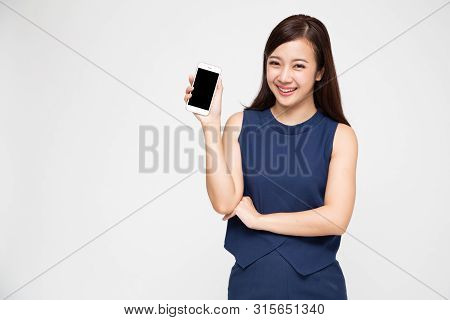 Portrait Of Beautiful Asian Wowan Showing Or Presenting Mobile Phone Application On Hand Isolated Ov