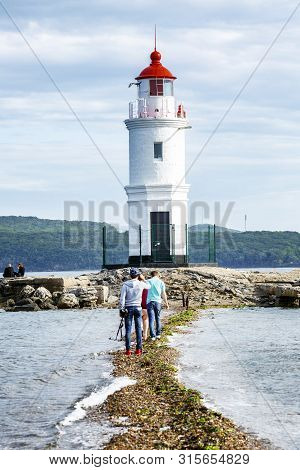 Vladivostok, Russia, 09/20/2017: People Walking At The Lighthouse. Beautiful Landscape.