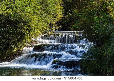 The small Croatian town of Slunj. Beautiful sunny day. Magnificent cascade of waterfalls on the river Sluncica. The concept of ecological, active and photo tourism