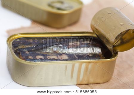 An Opened Can Of Sardines Or Herring In Olive Oil On Brown Paper. Sea Food Full Of Omega 3 Fat.