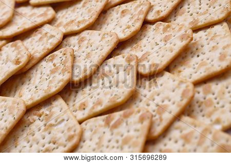Tuc Original Snack Crackers Lies On Market Table Stacked In Big Pile