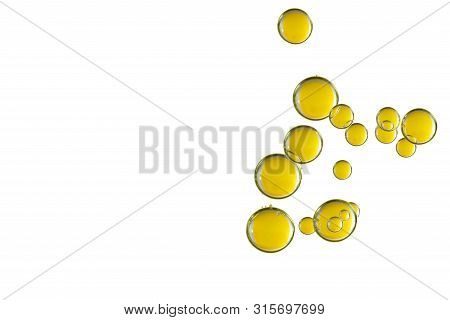 A Gorup Of Shiny Yellow Bubbles Isolated Over A White Background.