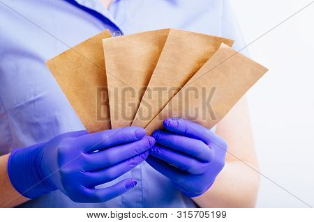 Bags For The Sterilization Of Instruments In The Hands Clad In Sterile Gloves.