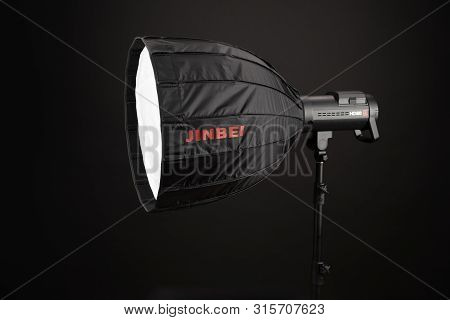 A Modern Electric Saturated Black Octobox On A Tripod. A Huge Octobox Over Black Background. Equipme