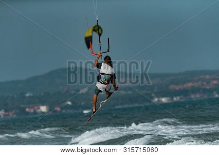 Kitesurfing on the waves of the sea in Mui Ne beach, Phan Thiet, Binh Thuan, Vietnam. Kitesurfing, Kiteboarding action photos Kitesurfer In action