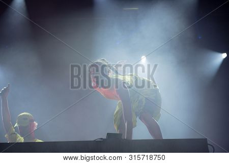 Woman Performer Singing On Stage
