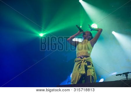 Woman Performer Singing On Stage