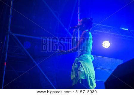 Woman Performer Singing On Stage