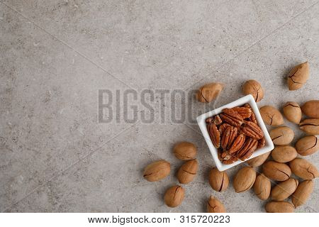 Frame Of Pecan Nuts On Marble Background. Square Bowl Of Nuts In The Corner