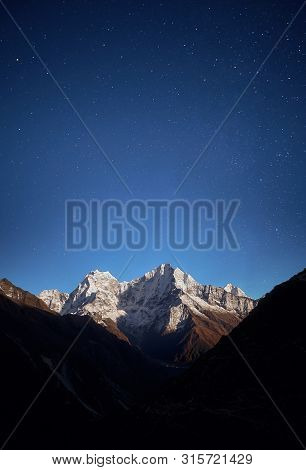 Thamserku Mountain Night View In The Light Of The Rising Moon.