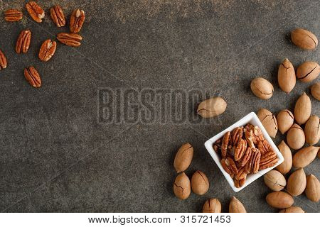 Frame Of Pecan Nuts On Marble Background. Square Bowl Of Nuts In The Corner