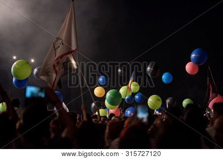 Crowd Of People Playing With Balloons At Music Festival