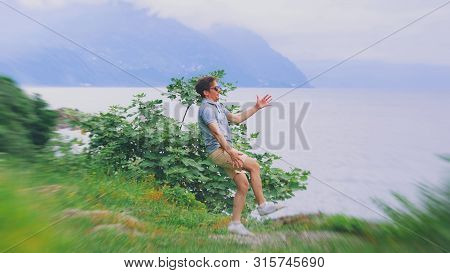 Man Suffering From Dizziness With Difficulty Standing Up While Climbed A Mountain. Danger Hiking In 