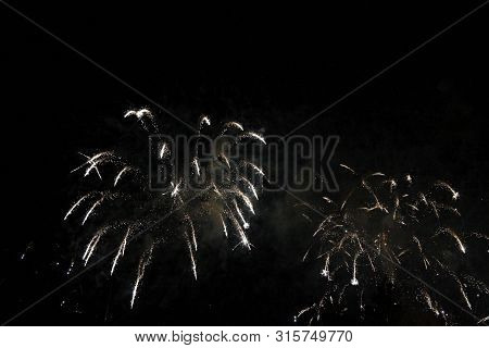 The Celebration Colored Firework Flashing In The Black Night Sky Background