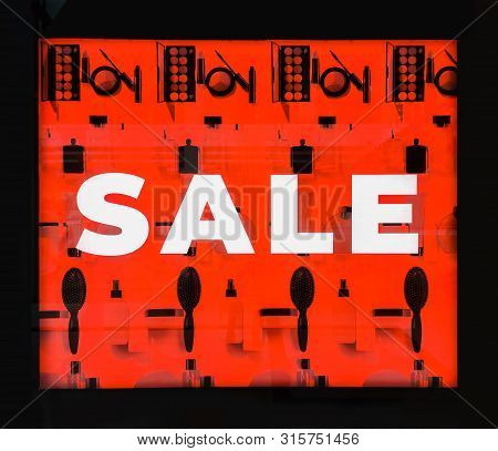 Seasonal Discounts In The Store. Big Red Banner With Text Sale On A Shop Window. Black Friday In Sto