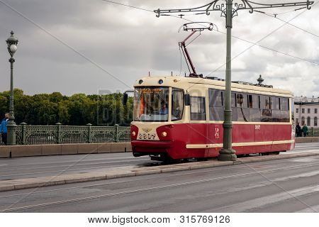 St. Petersburg, Russia - August 03, 2019: tram on Troitsky bridge on a summer day after rain. public urban transport in St.Petersburg