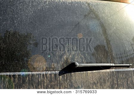 Tailgate Minibus Back Windo With A Wiper Of In Mud On A Sunny Day, Close Up Of The Back Door Of A Di