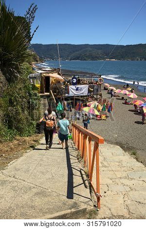 Niebla, Chile - February 2, 2016: Unidentified People Walking Down The Slope To The Sandy Beach Of N