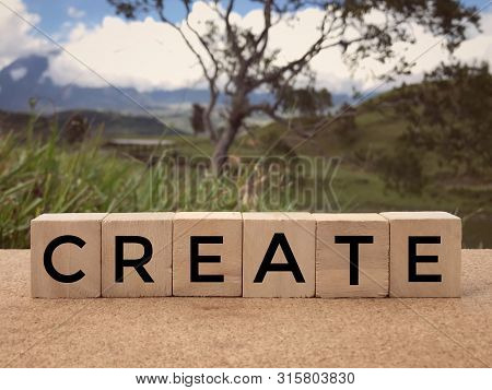Motivational And Inspirational Word - Create Written On Wooden Blocks. Blurred Styled Background.