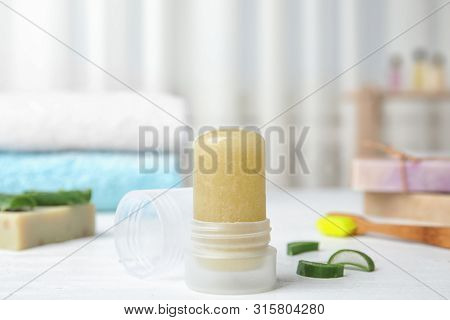 Natural Crystal Alum Deodorant And Aloe On White Wooden Table