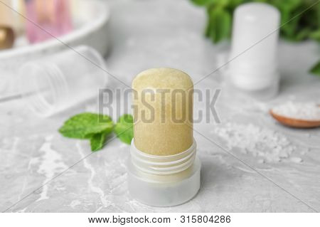 Natural Crystal Alum Deodorant And Mint On Light Grey Marble Table