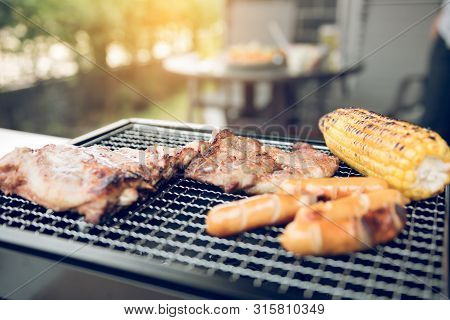Close Up Grill With Meat And Sausage Ready For Socializing Celebrate At Outsite Home.