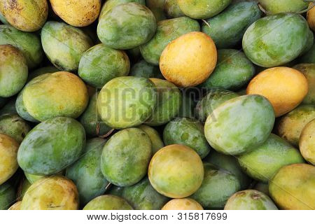 Pile Of Green Mango And Yellow Mango