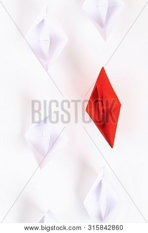 Red Paper Boat Among Other White. Leadership, White Crow, Individuality. Piranhas And A Shark. Not L