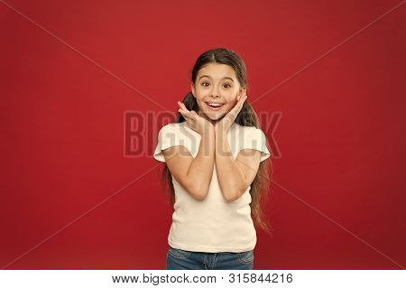 Little Girl Excited Smiling Face. Kid Happy Cute Face Feels Excited Red Background. Exciting Moments