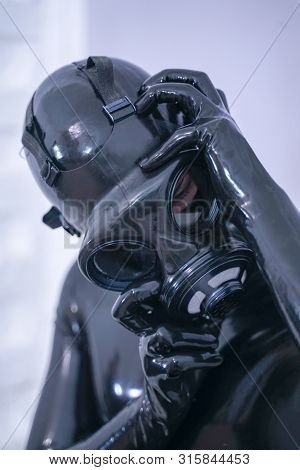 Man In The Latex Rubber Black Catsuit With Gasmask