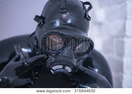 Man In The Latex Rubber Black Catsuit With Gasmask