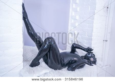 Man In The Latex Rubber Black Catsuit With Gasmask