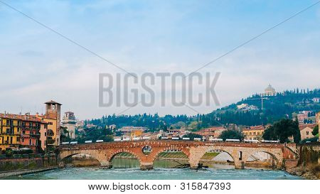 Roman Arch Bridge Over Adige River In Verona. Historical Center Of European City. Romantic Sightseen