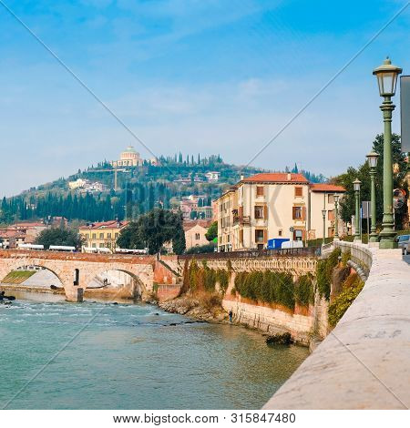 Roman Arch Bridge Over Adige River In Verona. Historical Center Of European City. Romantic Sightseen