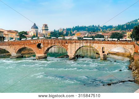 Roman Arch Bridge Over Adige River In Verona. Historical Center Of European City. Romantic Sightseen