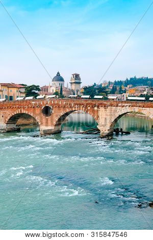 Roman Arch Bridge Over Adige River In Verona. Historical Center Of European City. Romantic Sightseen