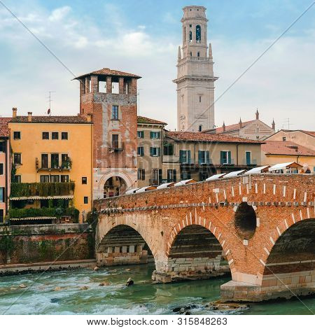 Roman Arch Bridge Over Adige River In Verona. Historical Center Of European City. Romantic Sightseen
