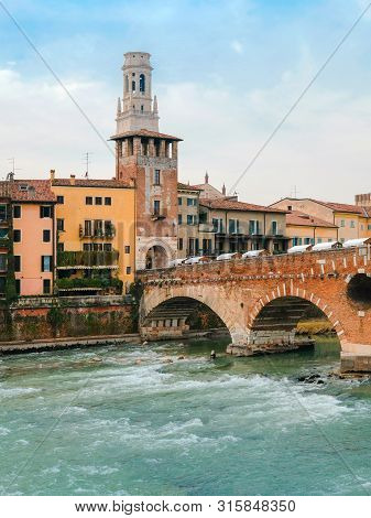 Roman Arch Bridge Over Adige River In Verona. Historical Center Of European City. Romantic Sightseen
