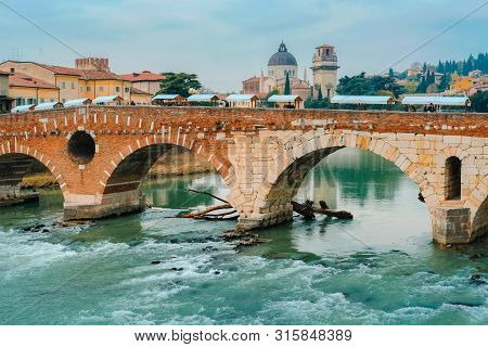 Roman Arch Bridge Over Adige River In Verona. Historical Center Of European City. Romantic Sightseen