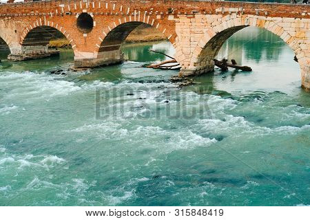 Roman Arch Bridge Over Adige River In Verona. Historical Center Of European City. Romantic Sightseen