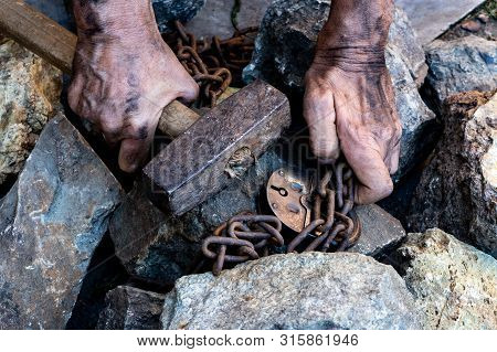 The Hands Of A Slave In An Attempt To Release. The Symbol Of Slave Labor. Hands In Chains.