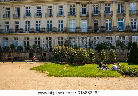 Nantes, France - May 12, 2019: People Rest On The Lawn On Le Cours Cambronne Square In The City Cent