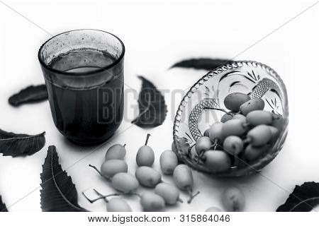 Detox Or Detoxifying Drink Of Neem Fruit In A Glass Isolated On White Along With Some Neem Fruit Or