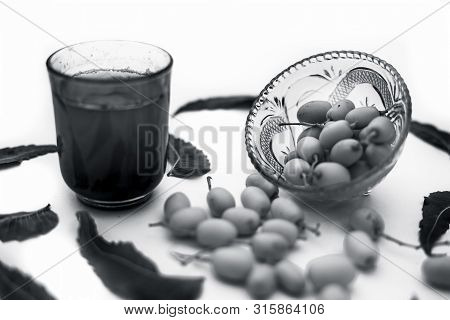 Detox Or Detoxifying Drink Of Neem Fruit In A Glass Isolated On White Along With Some Neem Fruit Or