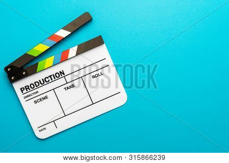 Top View Photo Of Open White Clapper Over Turquoise Blue Background. Minimalist Shot Of Clapper With